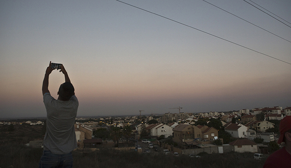 An Israeli teen takes a selfie, with the Gaza Strip in the background @ Nir Elias