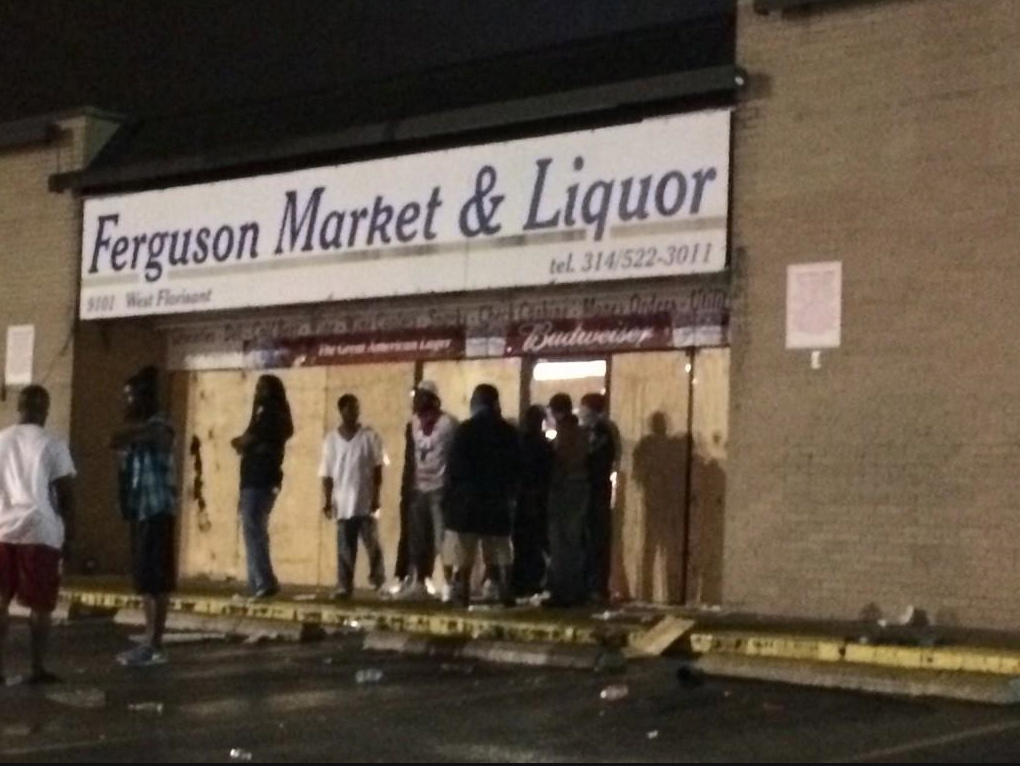 Concerned community ,members guard Ferguson liquor store © Trymaine Lee