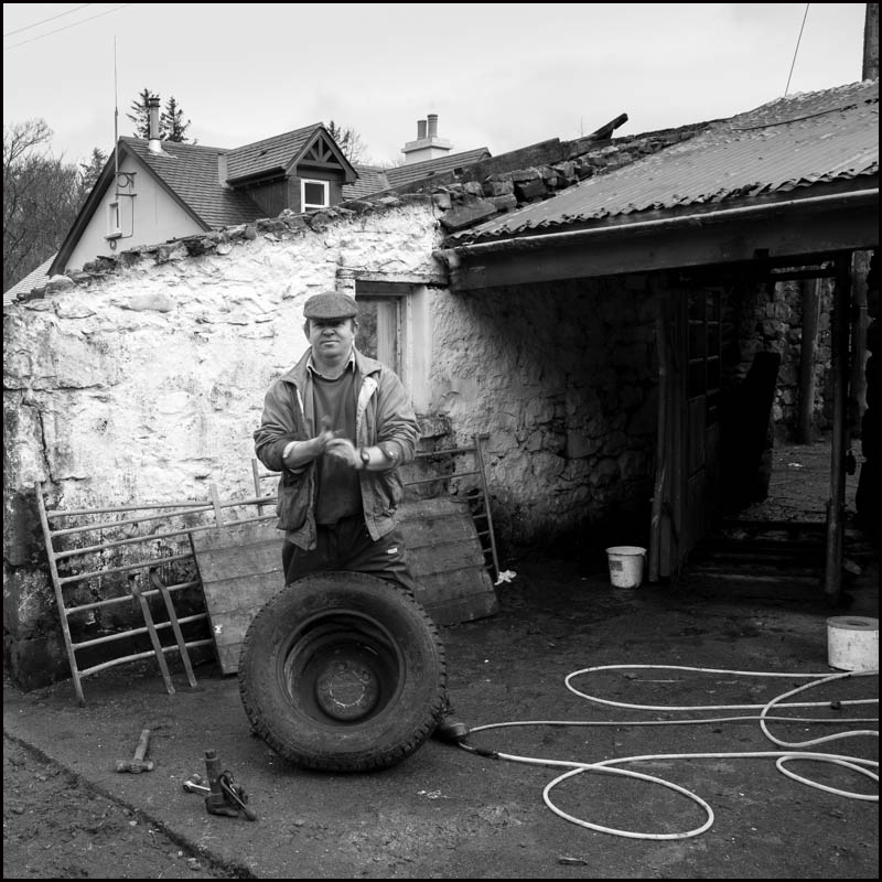 Donald MacLean, Hill Farmer, mending a tyre for the Land Rover, Isle of Mull © John MacPherson