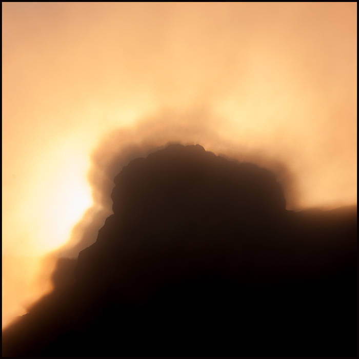 Sunrise behind Castle Geyser, light refracting and shadows cast on steam, Yellowstone © John MacPherson
