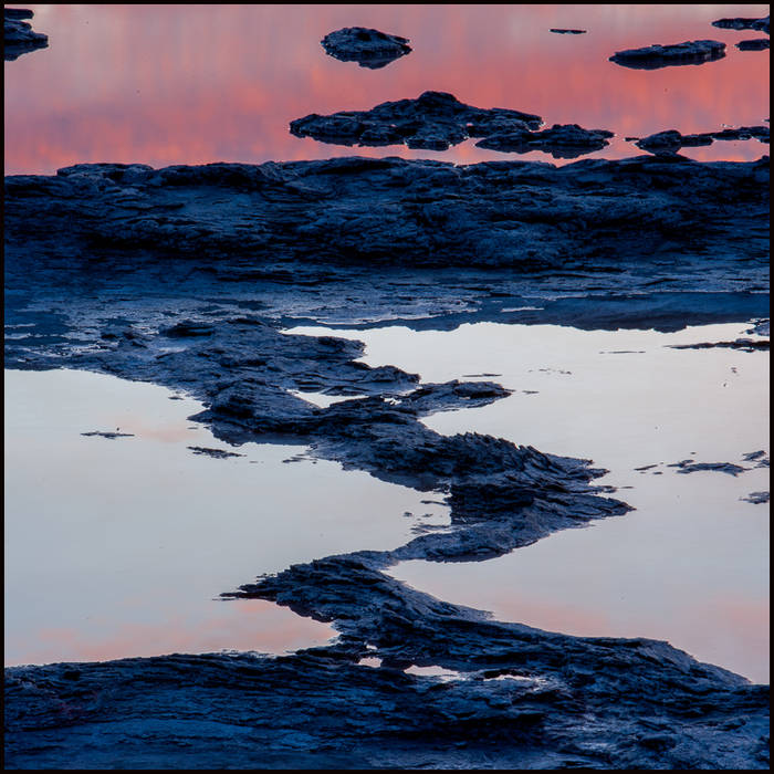 Landscape around geyser in late evening dim, sunset light from clouds reflected, Yellowstone © John MacPherson