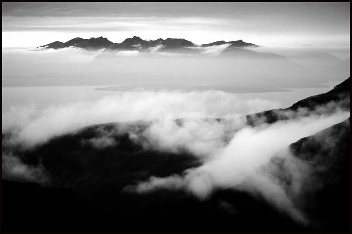 Mystical image of mist shaped like a man spilling over ridge on