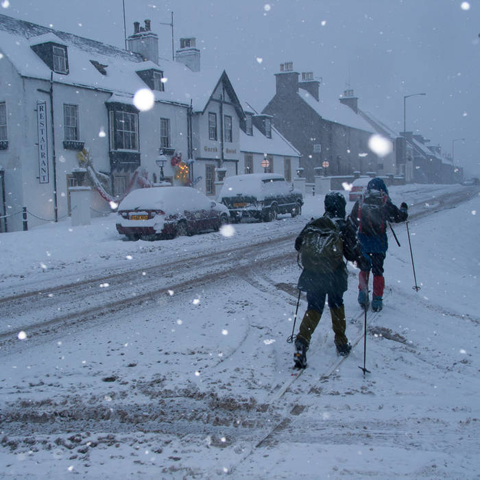Cross-country skiers in Grantown on Spey main street © John MacPherson