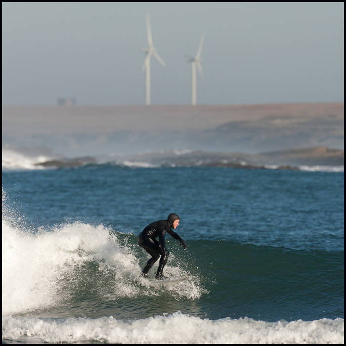 Surfers capitalize on big swells created by a February storm, Caithness © John MacPherson