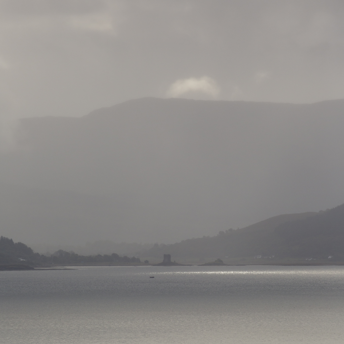 View across Loch Linnhe from Kingairloch to Appin and Castle Stalker through rain © John MacPherson